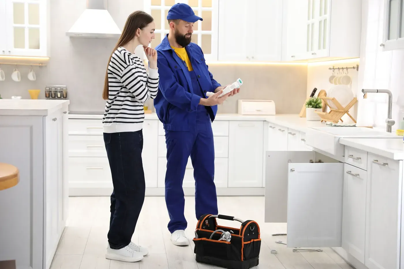A Fenwick technician going over a quote with a homeowner in her kitchen